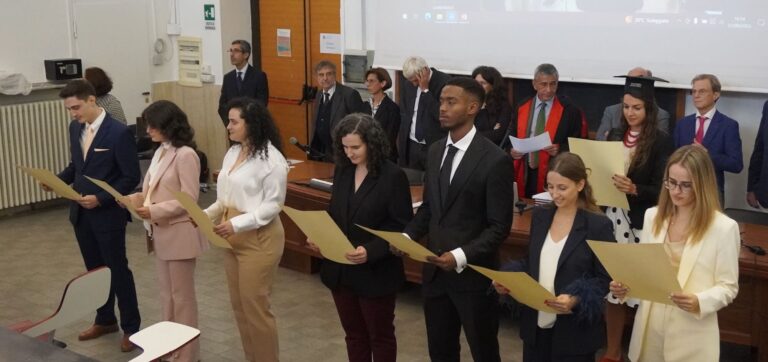A group of new proclaimed doctors graduating from Medicine in English in Italy, holding the hippocratic oath